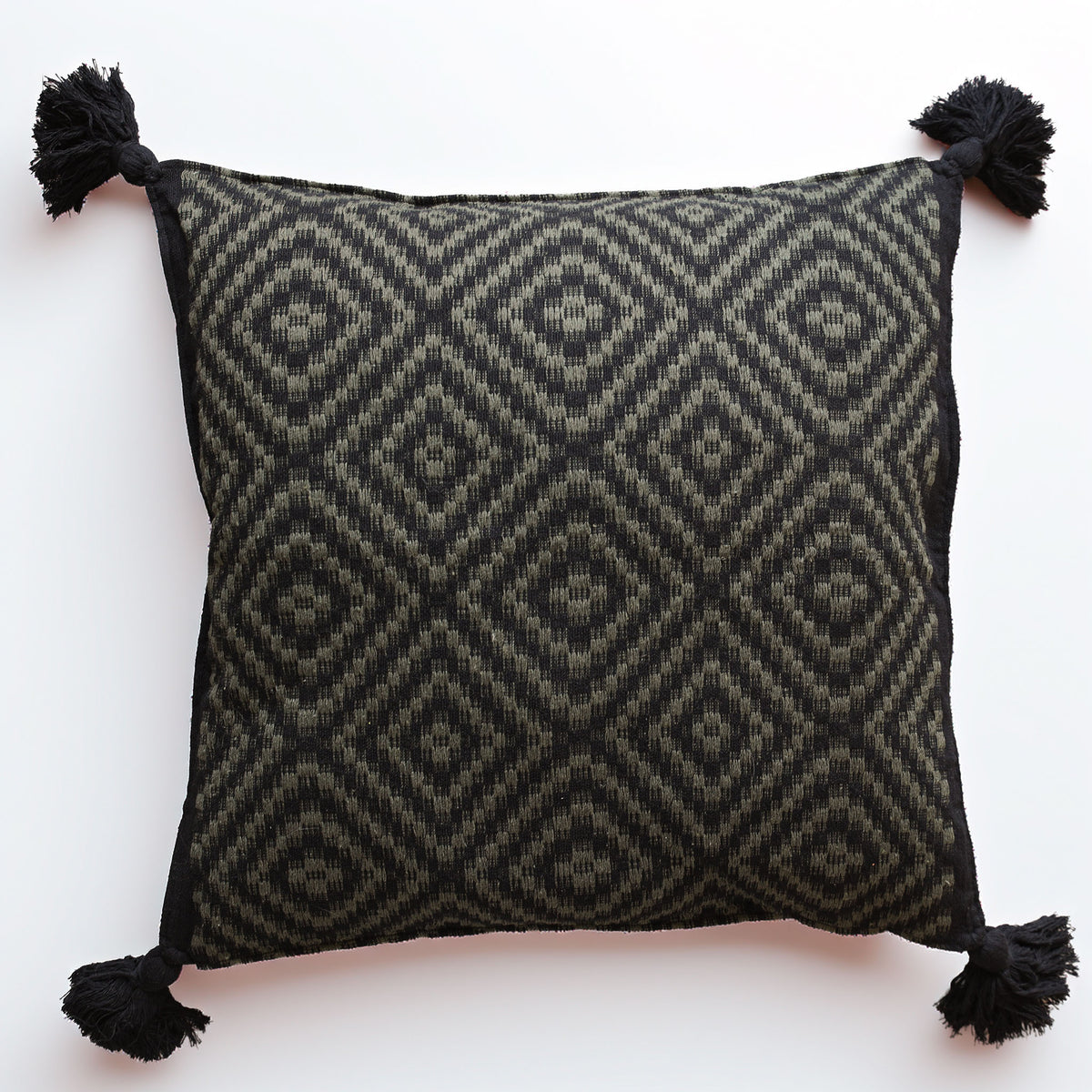 A square throw pillow featuring a black and olive green geometric diamond pattern, finished with black tassels on all four corners, set against a plain white background.