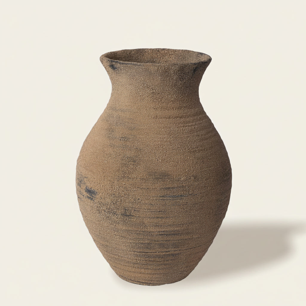 Umber ceramic vase on a white background