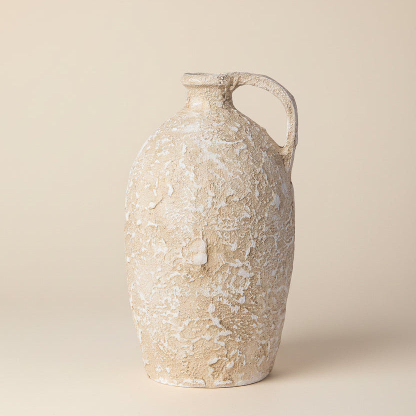 Beige ceramic vase with a handle on a white background