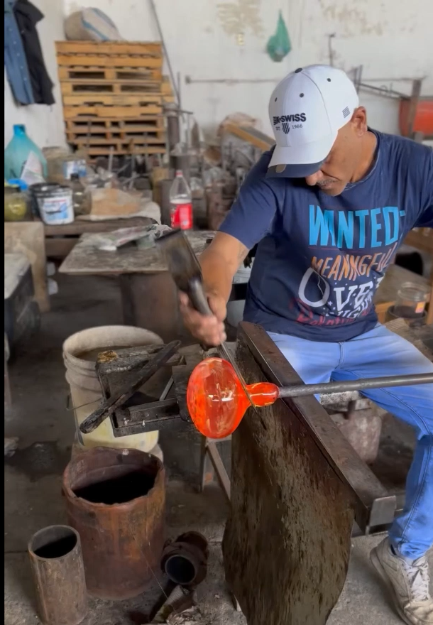 Person working with glass in a workshop setting
